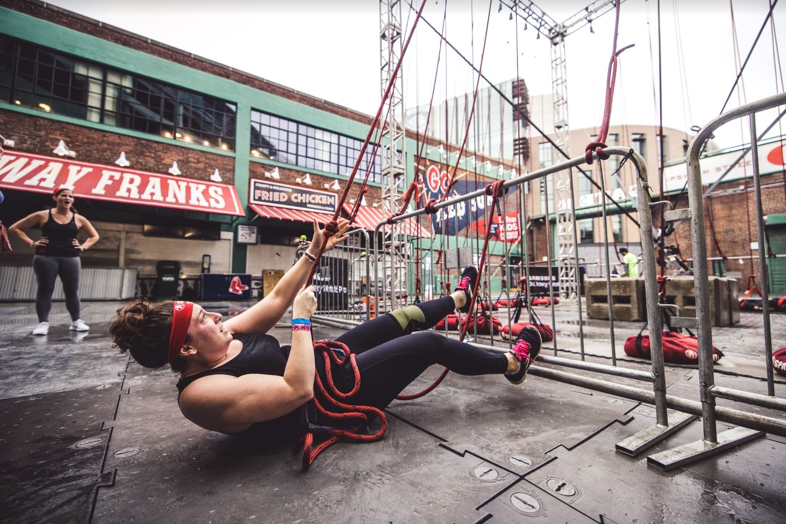 a spartan racer completing the hercules hoist obstacle at a stadion race